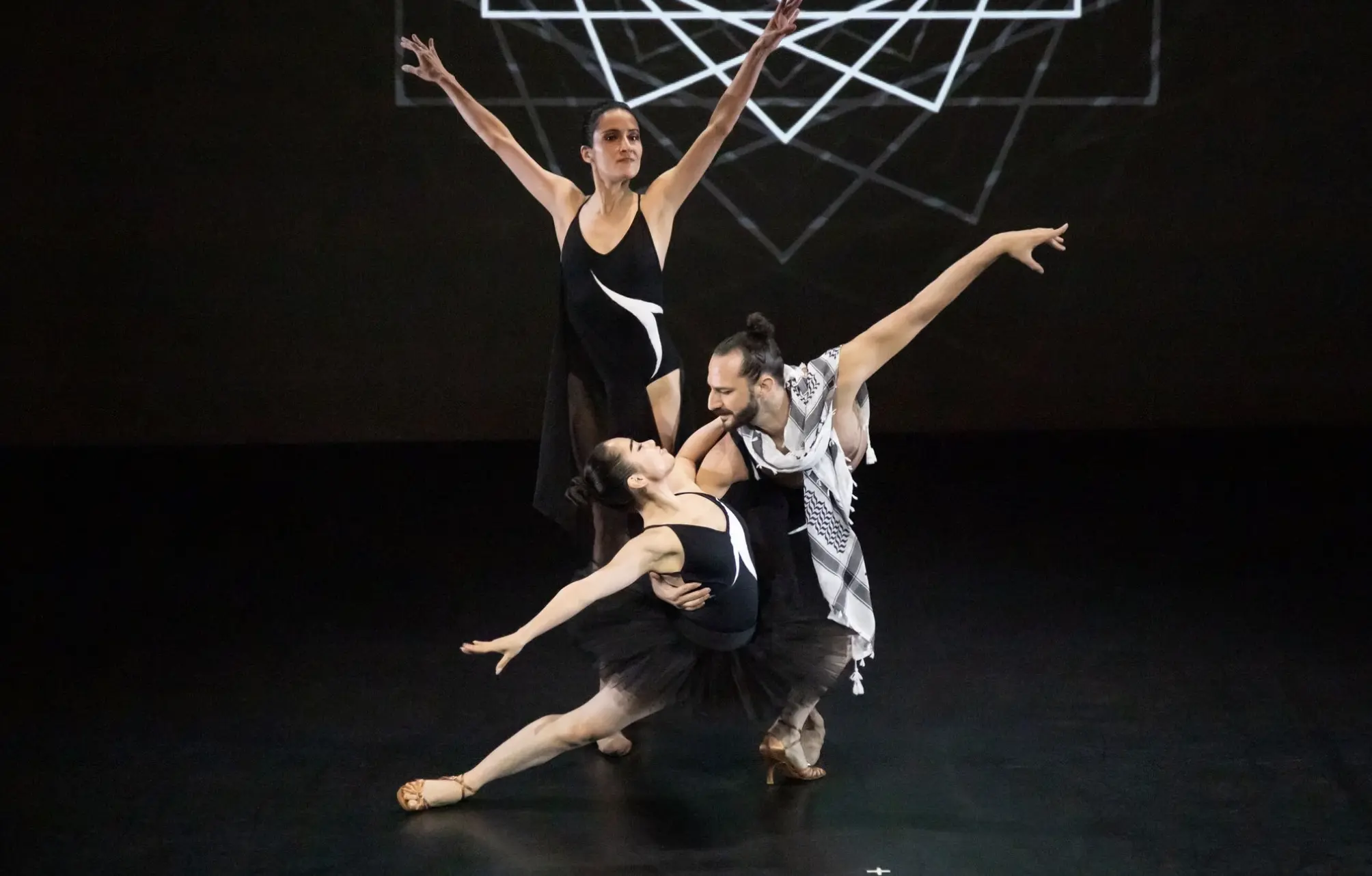 FJK Dance performers in a sculptural formation on stage